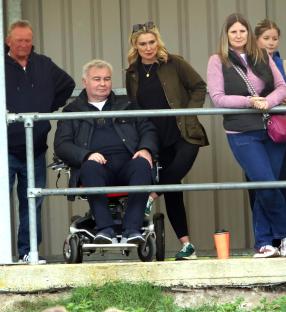 Family watching a football match.