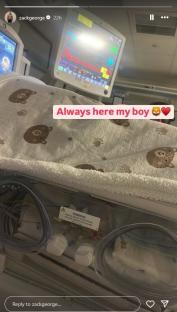 A hospital incubator with a baby blanket and the message "Always here my boy".