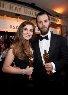Rachel Shenton and Chris Overton holding Oscars for Best Live Action Short Film.