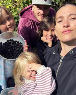 Family picking blackberries.