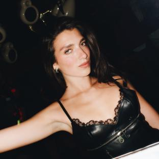 Woman in black leather top.