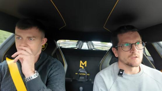 Two men in a Lamborghini.