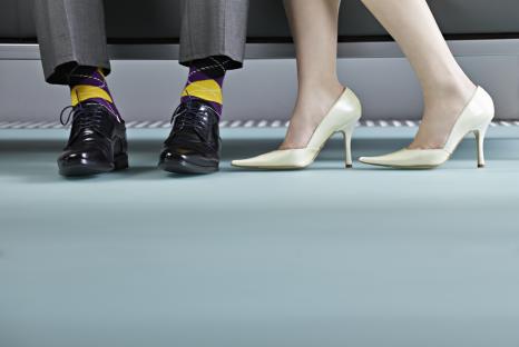 A young couple's feet in business attire.