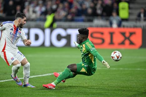 Andre Onana of Manchester United diving to save a goal during a soccer match.