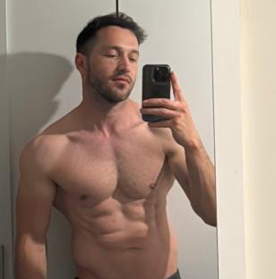 A man taking a selfie in a bathroom mirror.