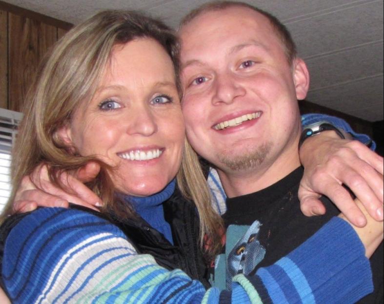 Raylee Reinhart and Benjamin Wilcock embracing and smiling.