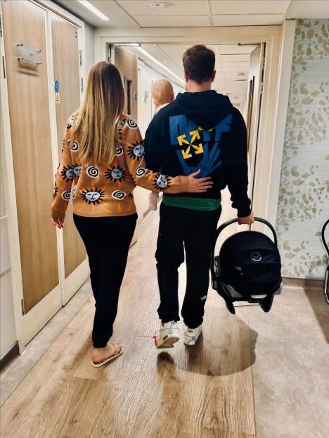 Olly Murs and his partner leaving the hospital with their newborn baby.