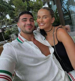 Tommy Fury and Molly-Mae Hague embracing outdoors.