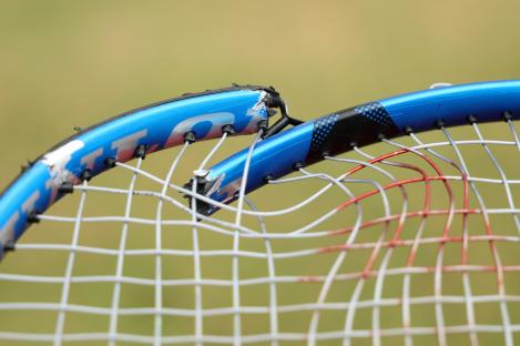 Close-up of a broken tennis racket.