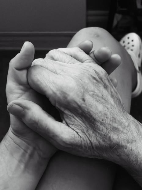 Black and white photo of two hands clasped together.