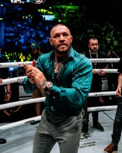 Conor McGregor clapping in a boxing ring.