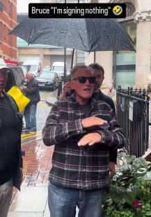 Bruce Springsteen refusing to sign autographs in the rain.
