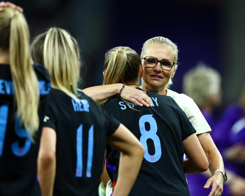 Sarina Wiegman, England Women's coach, embracing a player.