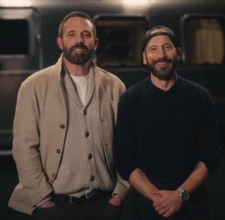 Two men standing side by side.