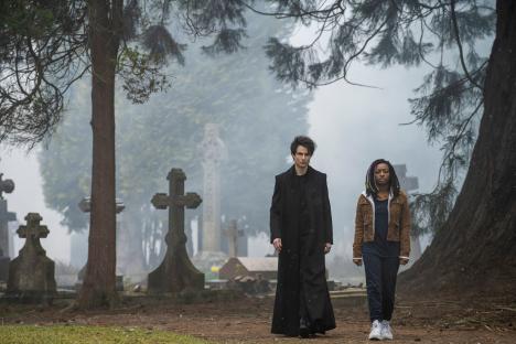 Tom Sturridge as Dream and Kyo Ra as Rose Walker walking in a cemetery.