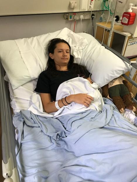 Georgia Lee in a hospital bed in Milton Keynes Hospital after suffering from encephalitis.