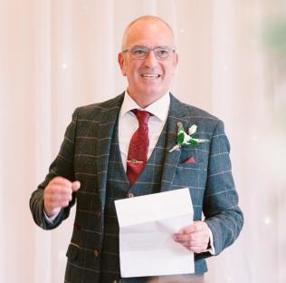 Man in suit giving a speech.