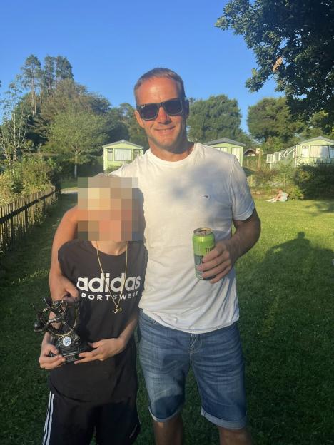 Photo of a man and child in a garden.