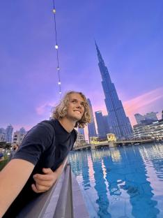 Young man in Dubai looking at the Burj Khalifa.