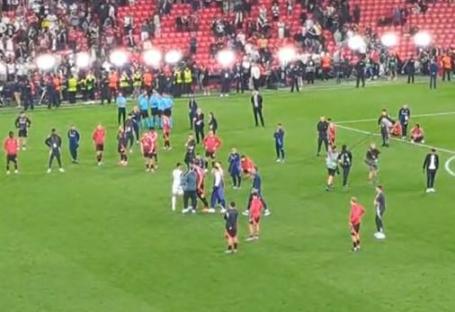 Soccer players on the field after a game.