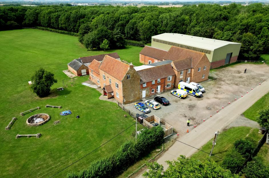 Aerial view of Stathern Lodge, a summer camp, with police cars and officers present.