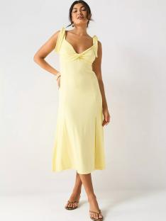 Woman in a pale yellow midi dress.