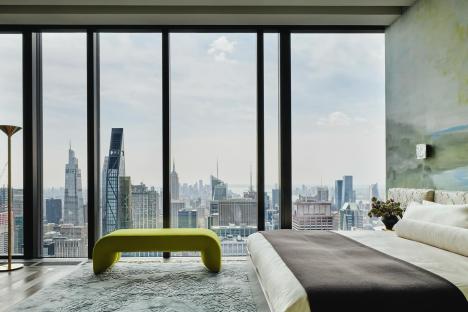 High-rise bedroom with city view.