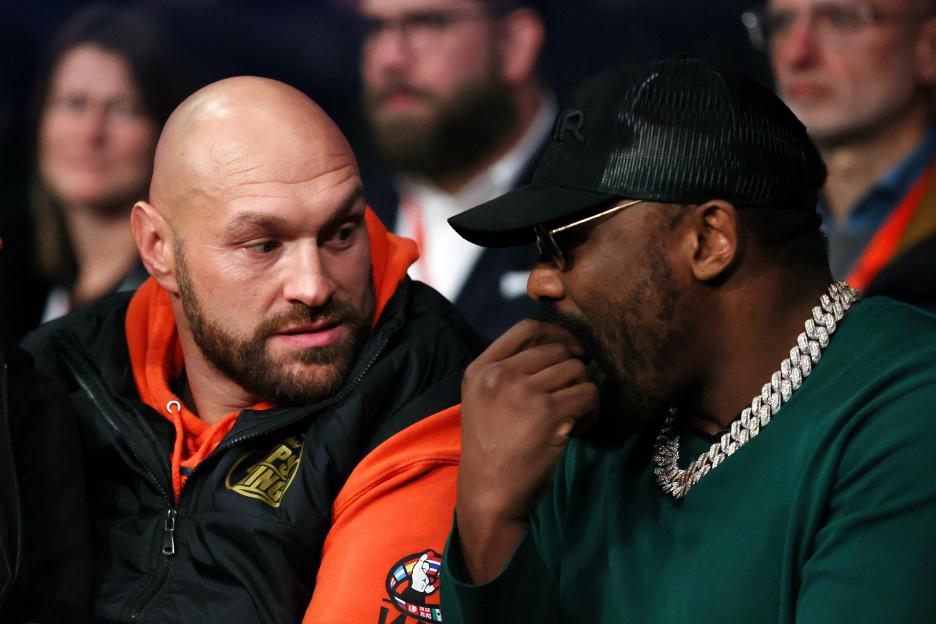 Tyson Fury and Derek Chisora ringside at a boxing match.