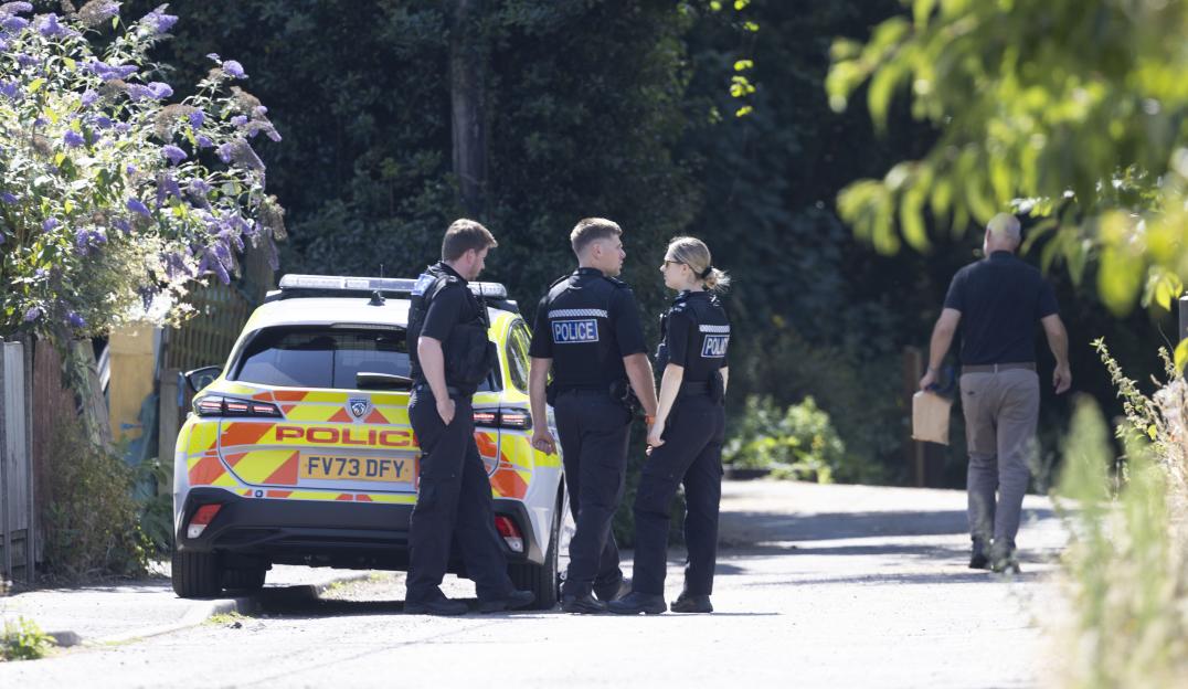 Police officers at a murder investigation scene.