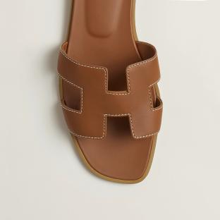 Brown leather sandals with an H-shaped cutout.