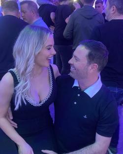 Couple smiling at each other at a party.
