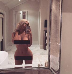 Selfie of Kim Kardashian in a bathroom mirror, nude with censored areas.