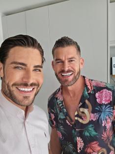 Two men smiling for a selfie.