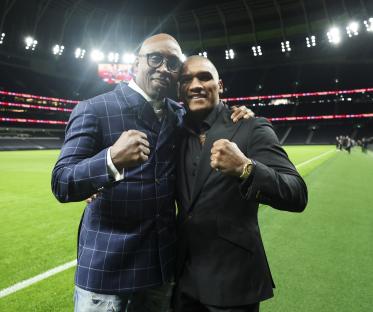 Conor Benn and his father Nigel Benn on a soccer field.