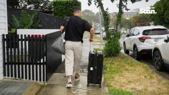 Man leaving with luggage.