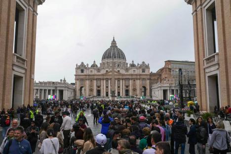 Large crowd of people queueing in St. Peter's Square to pay respects to Pope Francis.