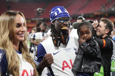 Yves Bissouma celebrates with his family after a UEFA Europa League victory.