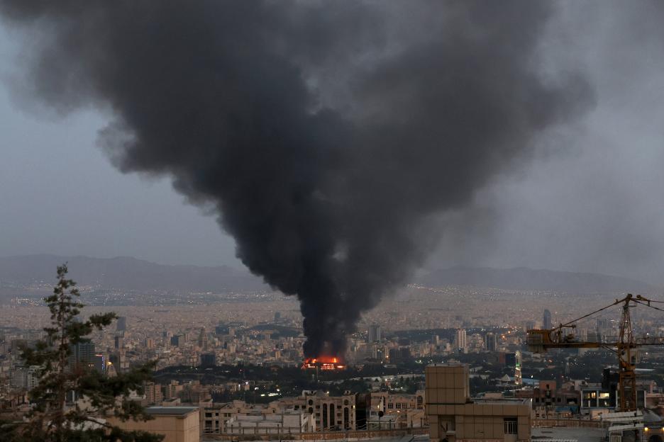Smoke rising from a burning building in Tehran, following an Israeli strike.