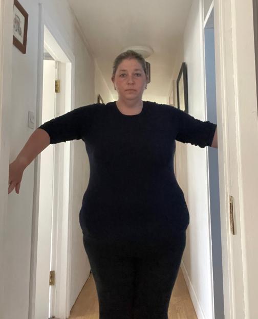 Woman standing in a hallway.