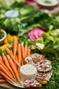 Spring vegetable board with cheese and radish crostini.