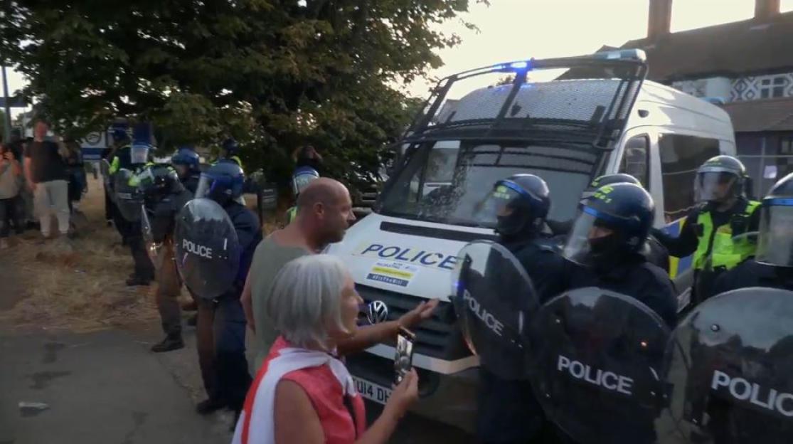 Riot police confronting protesters.