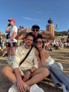 Three people posing at a music festival.