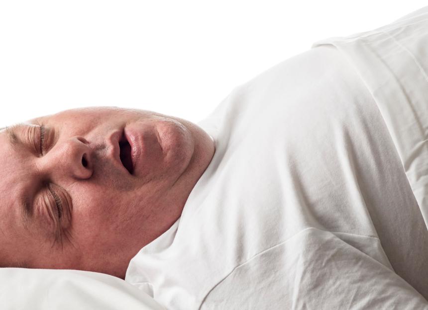 Overweight man sleeping with mouth open.