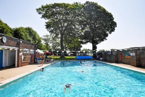 Swimmers at an outdoor pool.