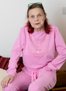 Portrait of a woman in a pink tracksuit.