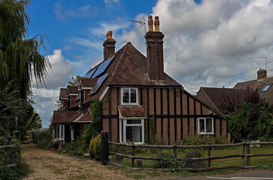 A half-timbered house with solar panels on the roof.