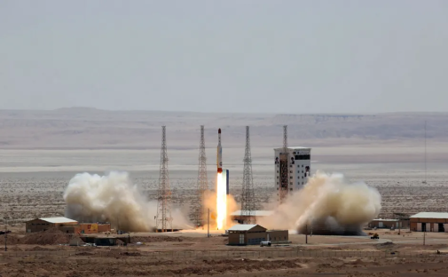 Rocket launching from a desert launchpad.