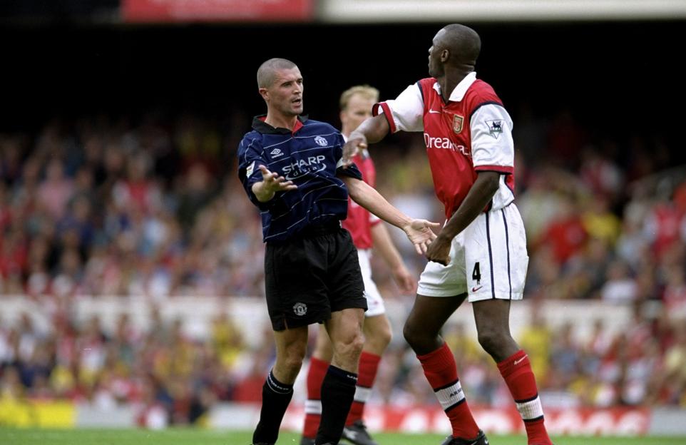 Roy Keane of Manchester United and Patrick Vieira of Arsenal clashing during a soccer match.