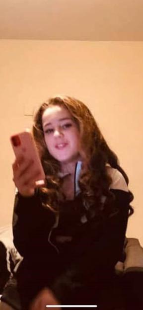 Photo of Scarlett, a missing 16-year-old girl with long dark hair.