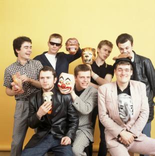 Madness band members posing with clown masks.